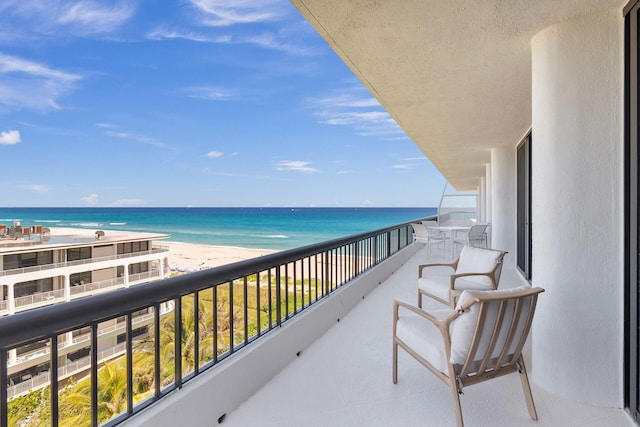 balcony with a beach view and a water view