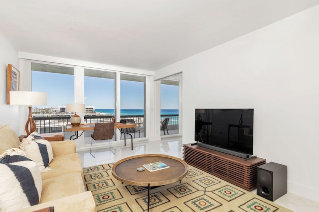 tiled living room featuring a water view