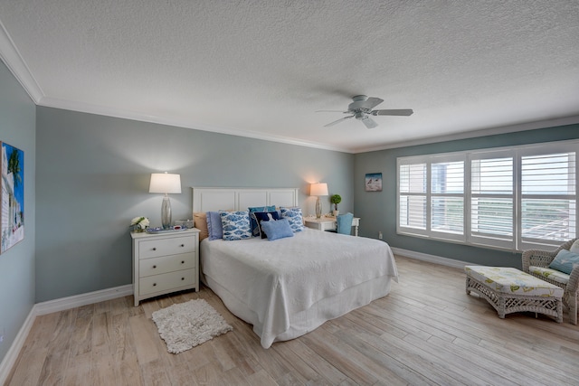 bedroom with crown molding, light hardwood / wood-style flooring, ceiling fan, and a textured ceiling