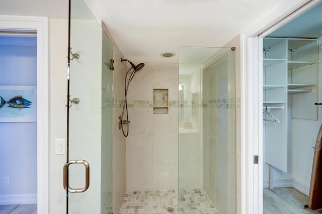 bathroom featuring walk in shower and hardwood / wood-style floors