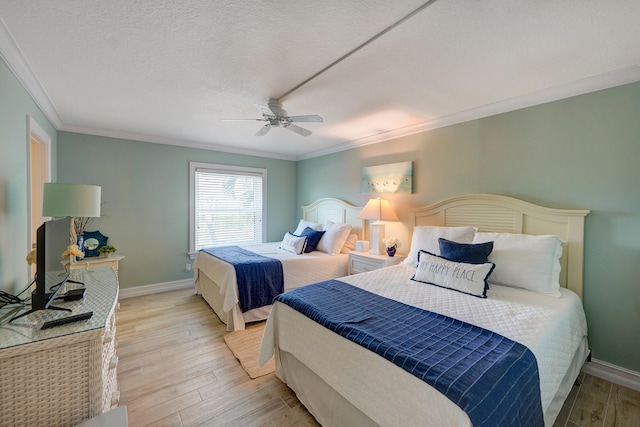 bedroom with a textured ceiling, ceiling fan, crown molding, and hardwood / wood-style flooring