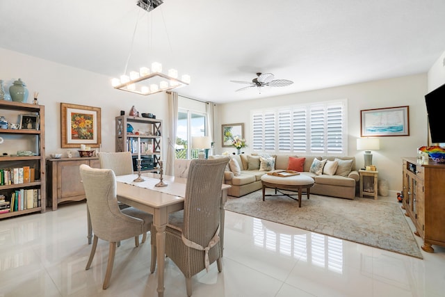 tiled dining room with ceiling fan with notable chandelier