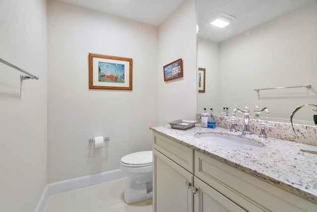 bathroom featuring vanity, tile patterned floors, and toilet