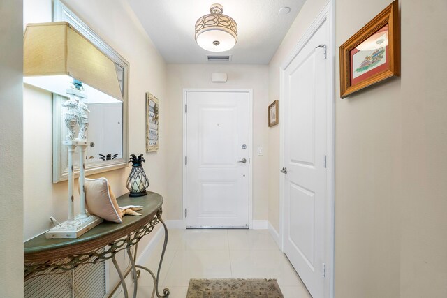 doorway featuring light tile patterned flooring