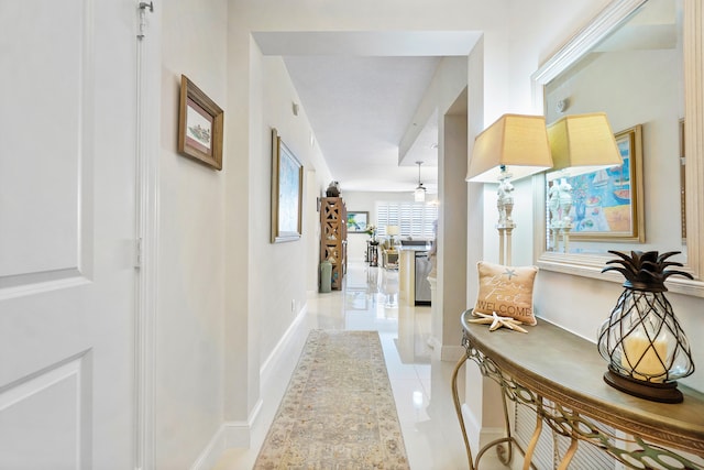 hall featuring light tile patterned flooring