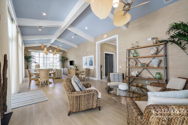 living room featuring light hardwood / wood-style flooring, lofted ceiling with beams, and ceiling fan