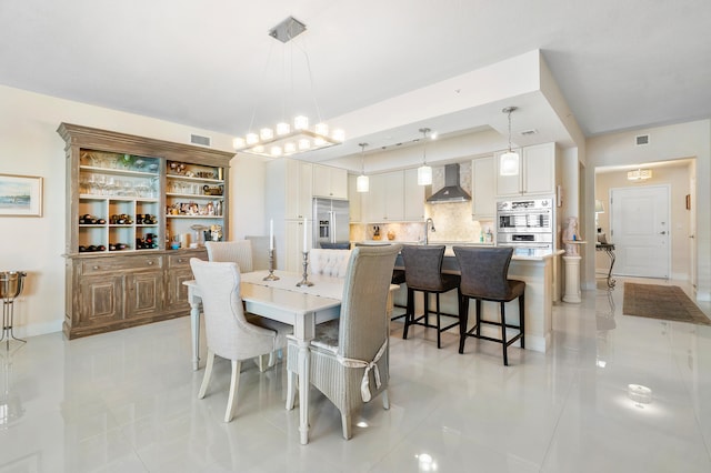 dining space with sink and light tile patterned floors