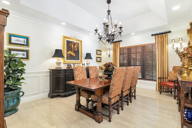 dining area featuring crown molding, a notable chandelier, and a tray ceiling