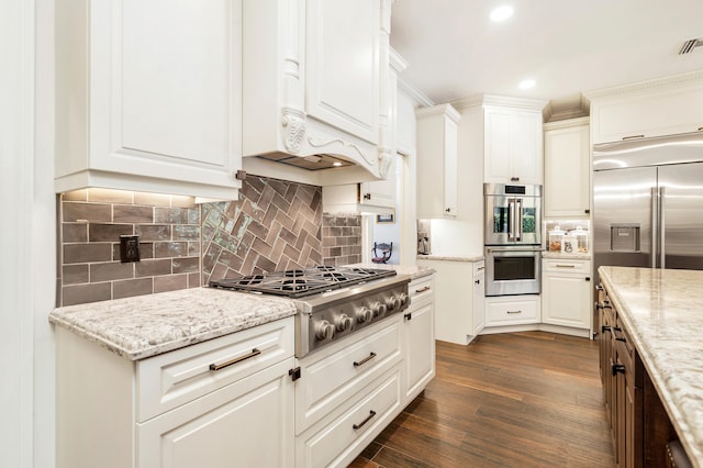 kitchen featuring white cabinetry, light stone countertops, and stainless steel appliances