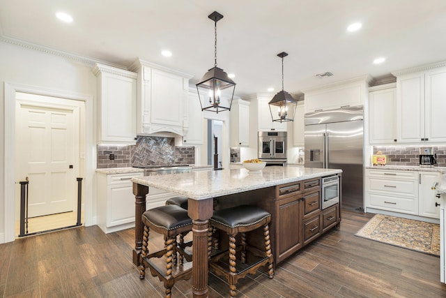 kitchen featuring white cabinetry, decorative backsplash, and stainless steel appliances