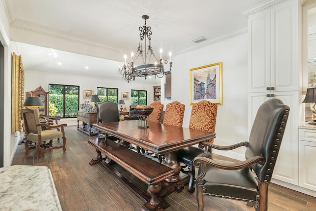 dining space with ornamental molding and dark hardwood / wood-style flooring