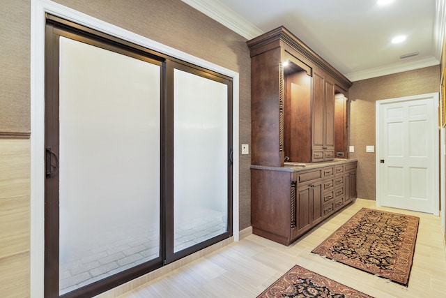 interior space with vanity, hardwood / wood-style flooring, and ornamental molding