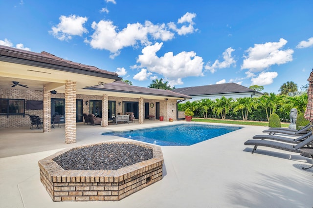 view of swimming pool with ceiling fan and a patio