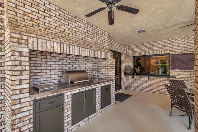 view of patio featuring area for grilling and sink