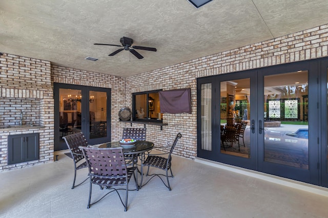 view of patio / terrace featuring sink, ceiling fan, and french doors