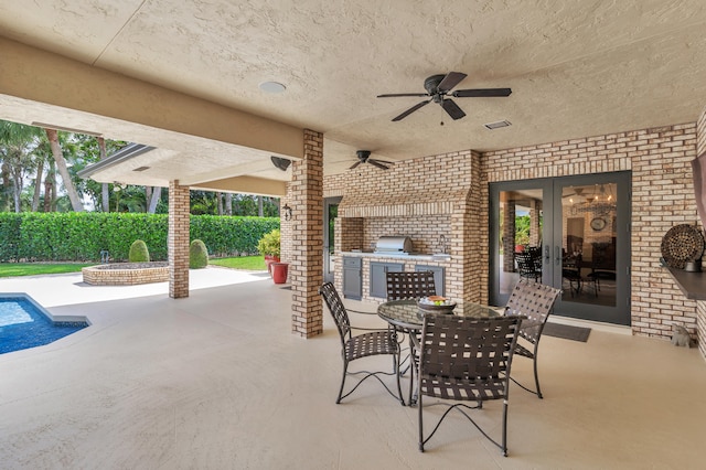 view of patio featuring french doors, ceiling fan, and exterior kitchen