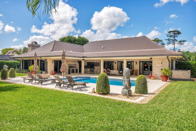 back of property featuring a yard, a patio area, and french doors