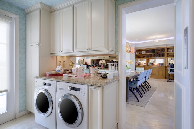 laundry area featuring cabinets and washing machine and dryer