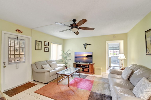 tiled living room with ceiling fan