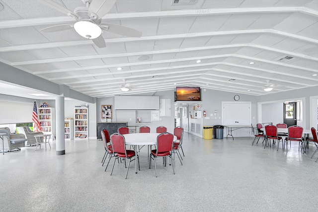 dining space with ceiling fan and lofted ceiling