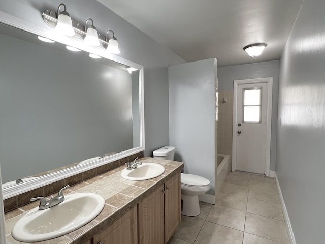 full bathroom with tile patterned floors, tiled shower / bath, vanity, and toilet