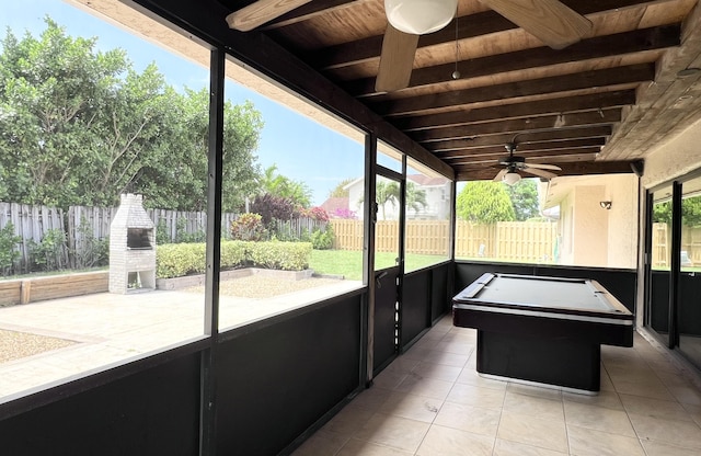 sunroom featuring beam ceiling, wood ceiling, ceiling fan, and billiards