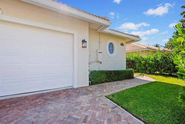 exterior space with a yard and a garage