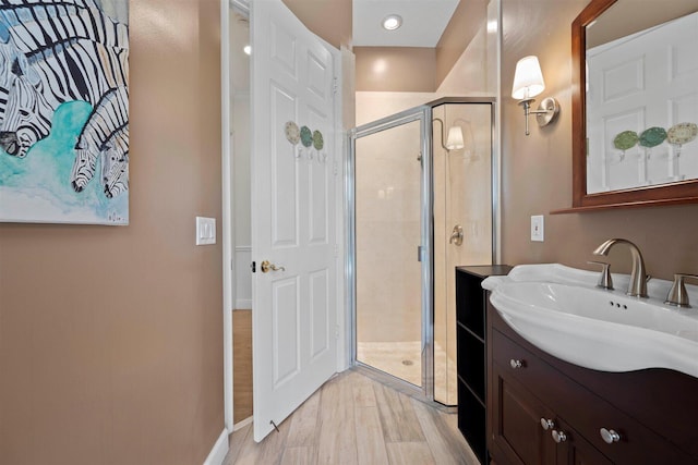 bathroom featuring vanity and an enclosed shower