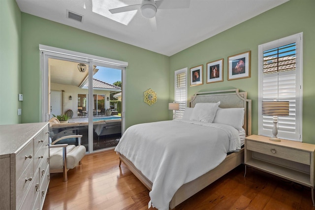 bedroom featuring wood-type flooring, ceiling fan, and access to outside