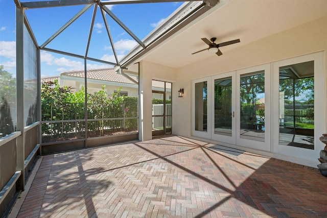 unfurnished sunroom with ceiling fan