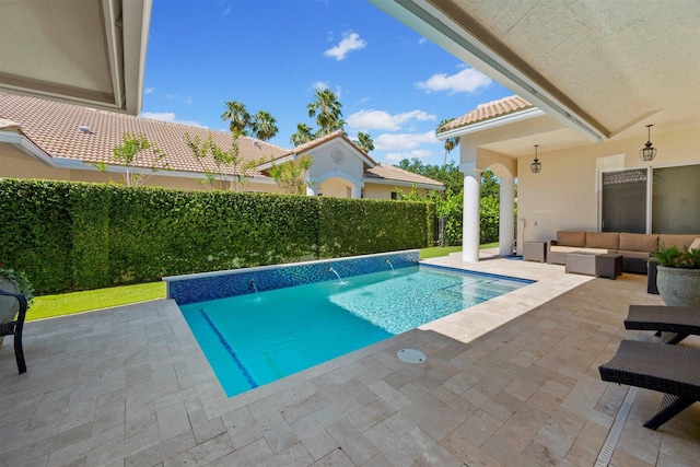 view of swimming pool featuring an outdoor hangout area, pool water feature, and a patio area