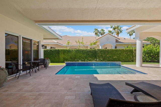 view of pool featuring pool water feature and a patio area