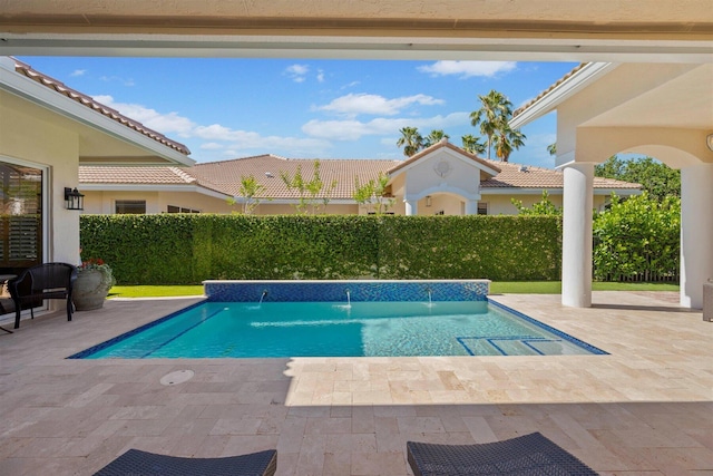 view of swimming pool featuring pool water feature and a patio area