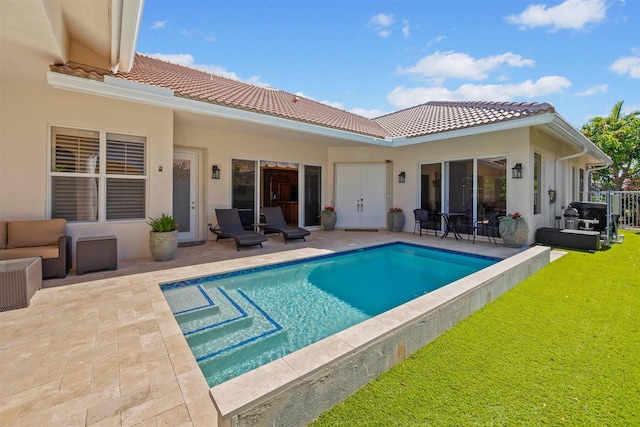 view of pool featuring a patio, a yard, and an outdoor living space