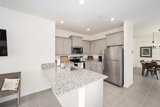 kitchen with a chandelier, stainless steel appliances, light tile flooring, gray cabinets, and sink