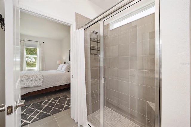 bathroom featuring a shower with door and tile flooring