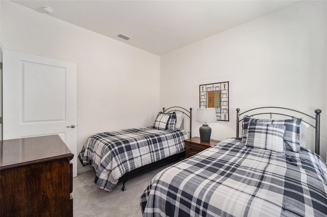 bedroom featuring light carpet