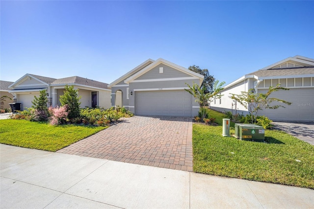 view of front of property featuring a front lawn and a garage