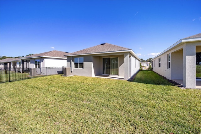 rear view of house with a lawn and a patio area