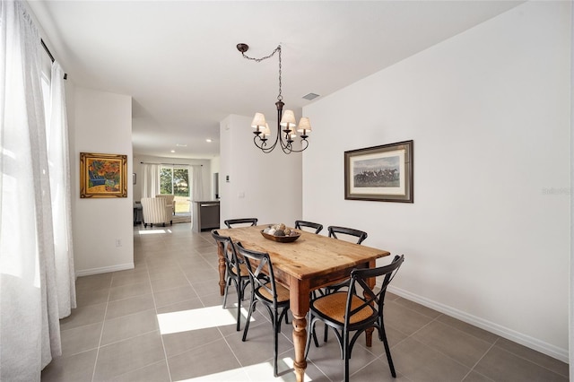 dining room with an inviting chandelier and light tile floors