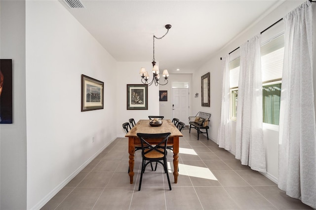 dining room with light tile floors and a chandelier