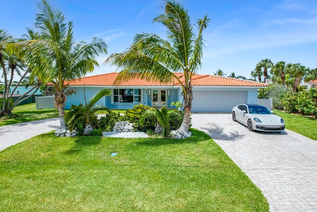 view of front of house featuring a garage and a front yard