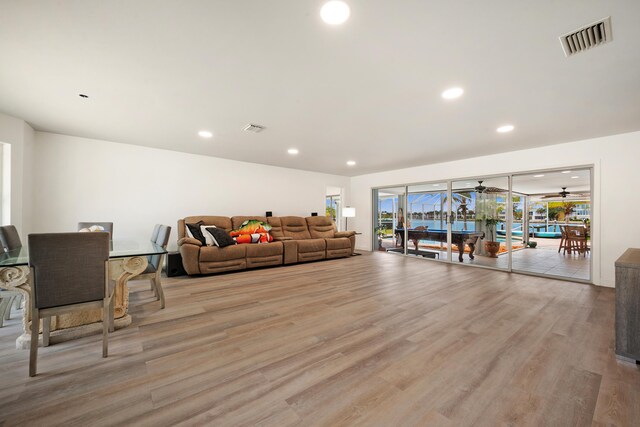 living room with hardwood / wood-style flooring and ceiling fan