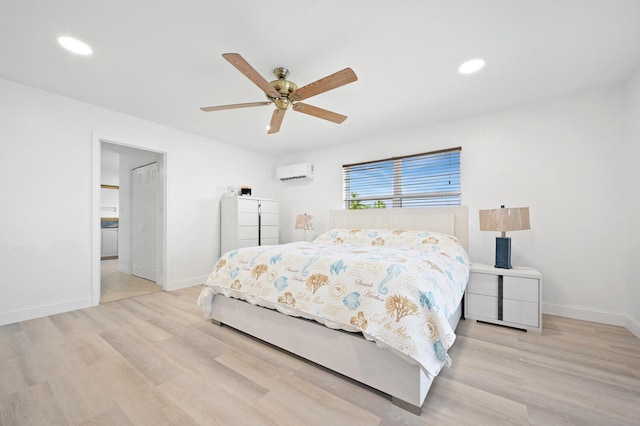 bedroom with an AC wall unit, light wood-type flooring, and ceiling fan