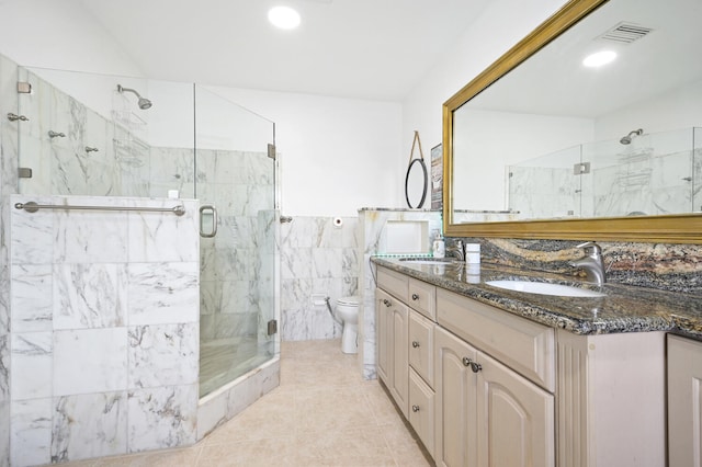 bathroom with tile patterned flooring, double sink vanity, toilet, and a shower with shower door