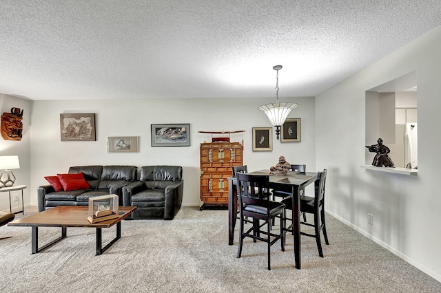 dining space with light carpet and a textured ceiling