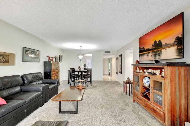 living room with light colored carpet and a textured ceiling