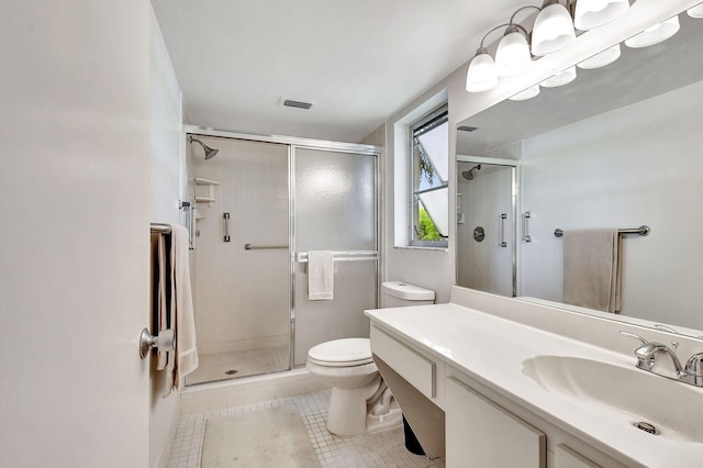 bathroom with vanity, a shower with shower door, and toilet