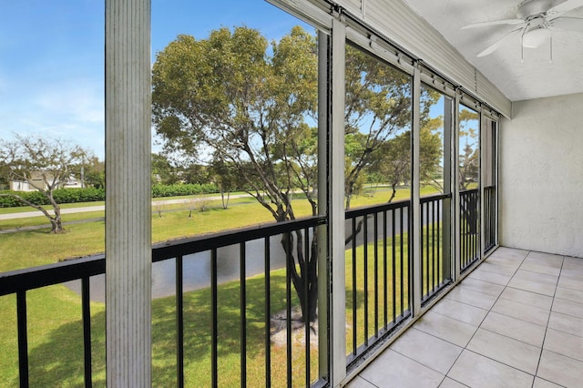 unfurnished sunroom with ceiling fan