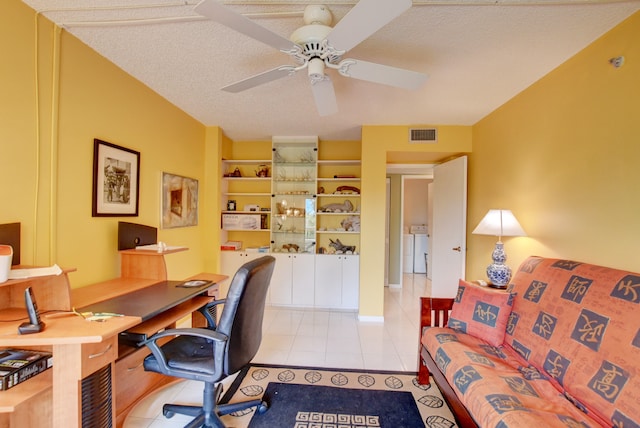 office featuring a textured ceiling, ceiling fan, and light tile floors